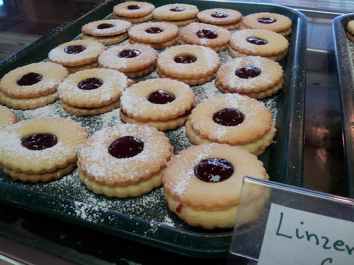 A tray of Linzer cookies dusted with icing sugar